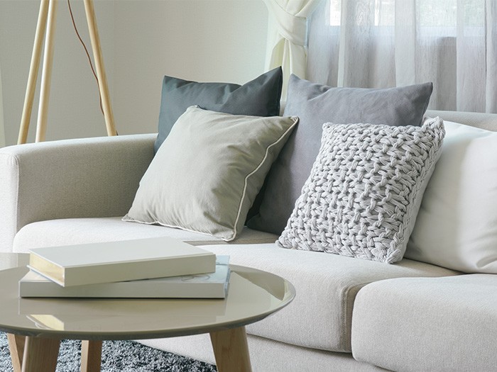 Neutral accent pillows that still add a pop of color to a natural toned gray sofa. 